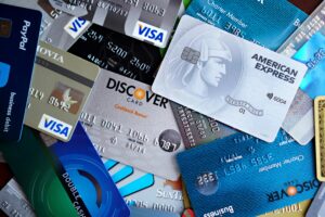 Close-up image of various credit cards including Visa, Mastercard, and American Express.